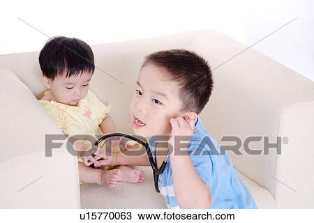 Boy using stethoscope to baby girl View Large Photo Image Stock Image - Boy using stethoscope to baby girl. Fotosearch