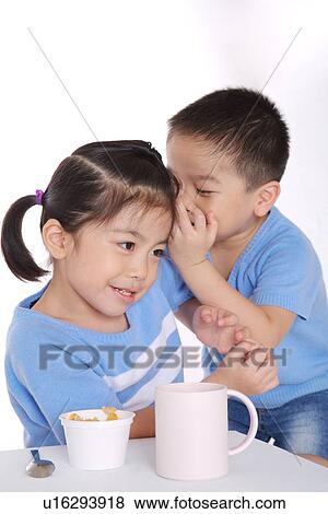 Boy whispering to girl View Large Photo Image Stock Photo - Boy whispering to girl. Fotosearch