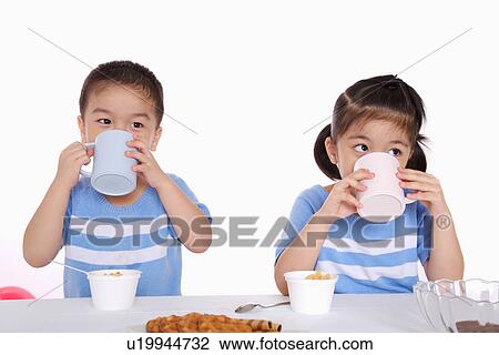 Children eating breakfast, portrait View Large Photo Image Stock Image - Children eating breakfast, portrait. Fotosearch