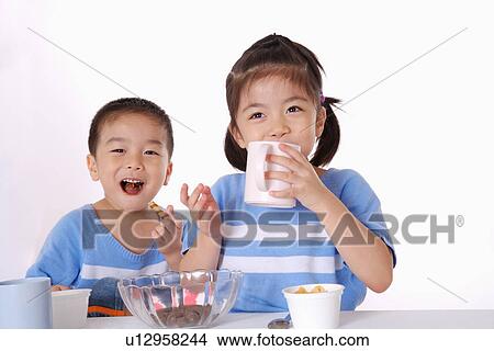 Children eating breakfast, smiling, portrait View Large Photo Image Picture - Children eating breakfast, smiling, portrait. Fotosearch