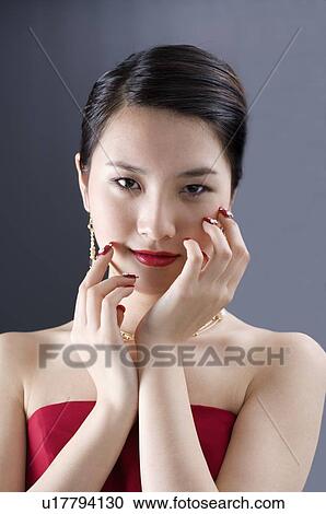 Smiling young woman, dressed up, hands touching face lightly View Large Photo Image Stock Image - Smiling young woman, dressed up, hands touching face lightly. Fotosearch
