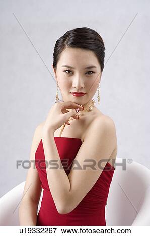 Young woman dressed up, hand on chin View Large Photo Image Stock Photo - Young woman dressed up, hand on chin. Fotosearch