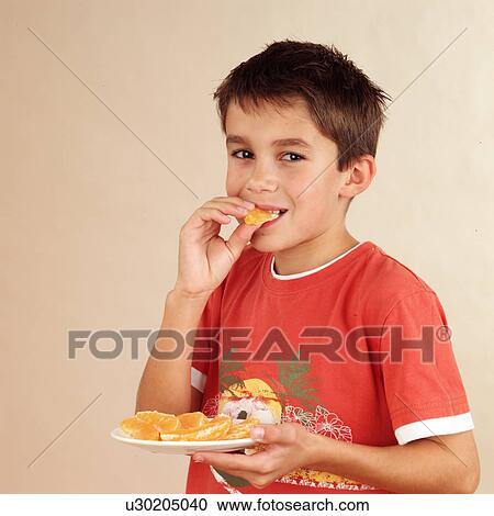 Child eating orange View Large Photo Image Stock Image - Child eating orange. Fotosearch