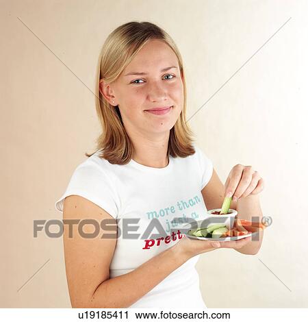 Stock Image - Child eating vegetable dip. Fotosearch