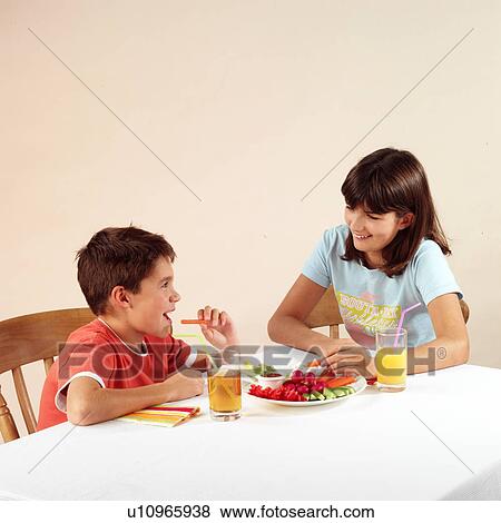 Stock Photo - Children eating and drinking. Fotosearch
