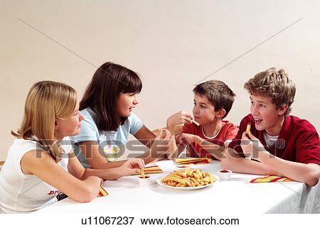 Children eating fries View Large Photo Image Stock Photo - Children eating fries. Fotosearch