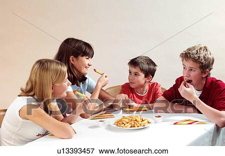 Children eating View Large Photo Image Stock Photo - Children eating. Fotosearch