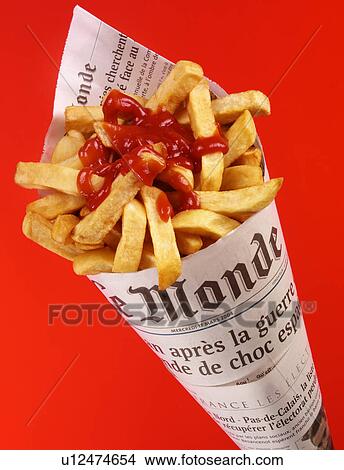 Chips / Fries In French Newspaper With Ketchup - Non Exclusive View Large Photo Image Picture - Chips / Fries In French Newspaper With Ketchup - Non Exclusive. Fotosearch