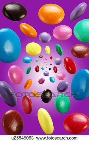 Flying chocolate candies View Large Photo Image Stock Image - Flying chocolate candies. Fotosearch