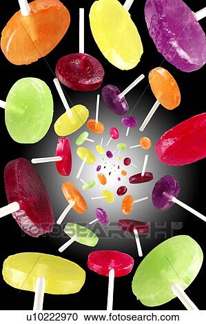 Flying lollypops on black View Large Photo Image Stock Image - Flying lollypops on black. Fotosearch