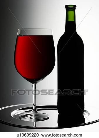 Stock Image - Glass of Red Wine With Bottle - Non Exclusive. Fotosearch