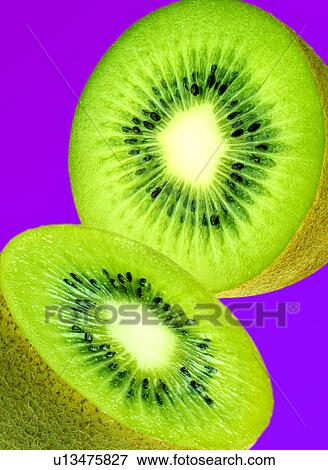 Stock Photo - Halved Kiwi fruit on purple. Fotosearch
