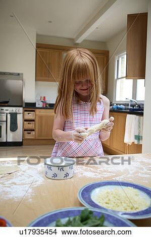 Young girl shaping pastry View Large Photo Image Picture - Young girl shaping pastry. Fotosearch