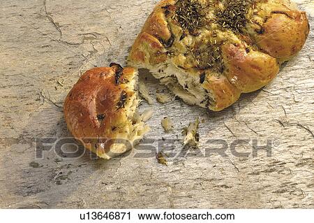 Stock Image - Broken herb bread (focaccia). Fotosearch