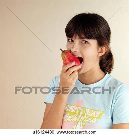 Stock Image - Child eating pear. Fotosearch