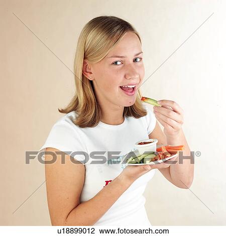 Stock Image - Child eating vegetable dip. Fotosearch