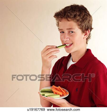 Stock Photo - Child eating vegetable dip. Fotosearch