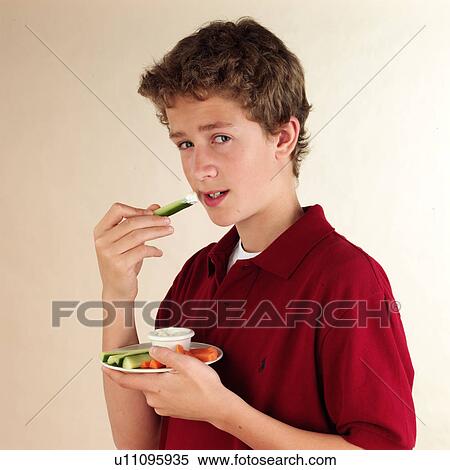 Stock Photography - Child eating vegetable dip. Fotosearch