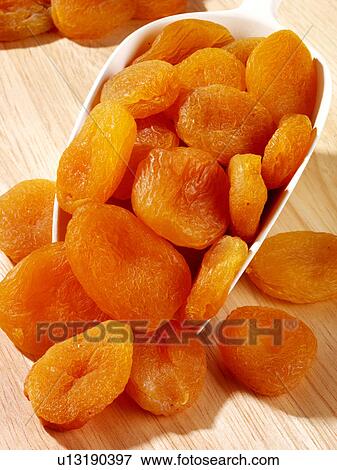 Stock Photo - Dried Apricots in Scoop - Non Exclusive. Fotosearch