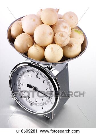 Stock Image - Kitchen Scales Filled With Turnips - Non Exclusive. Fotosearch