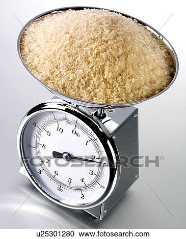 Stock Image - Kitchen Scales With Brown Rice - Non Exclusive. Fotosearch