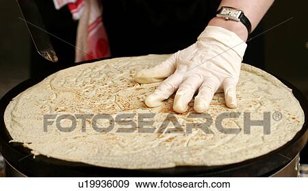 Large pancake on a hotplate, turned over with spatula and gloved hand View Large Photo Image Stock Photo - Large pancake on a hotplate, turned over with spatula and gloved hand. Fotosearch