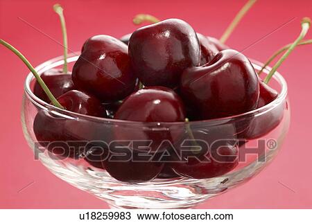 red cherries, a dessert bowl on a red background View Large Photo Image Stock Image - red cherries, a dessert bowl on a red background. Fotosearch