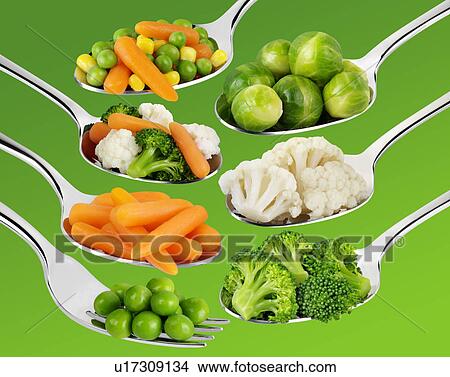 Picture - Spoons With Vegetables on Green - Non Exclusive. Fotosearch