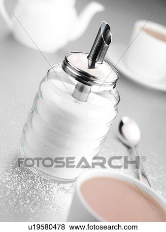 Stock Photo - Sugar sifter and cup of tea. Fotosearch