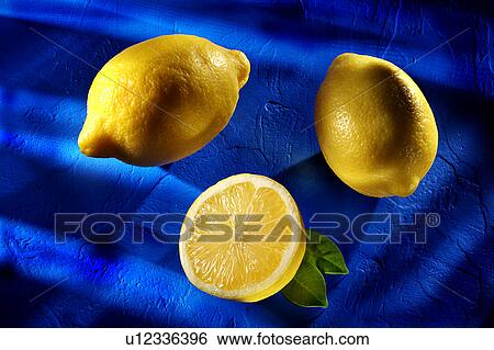 Stock Photograph - Three lemons on blue. Fotosearch