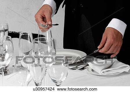 Picture - Waiter setting table. Fotosearch