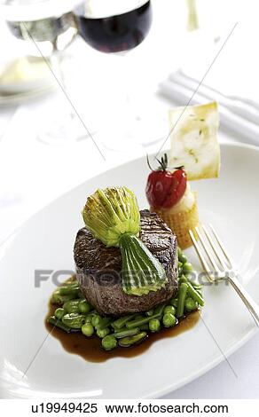 Stock Photography - Beef fillet on a bed of greens. Fotosearch