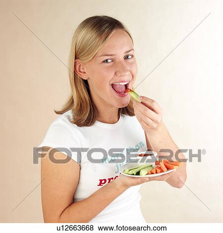 Stock Photo - Child eating vegetable dip. Fotosearch