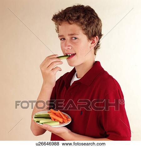 Stock Photo - Child eating vegetable dip. Fotosearch