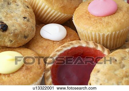 Stock Image - Eccles cakes, fairy cakes and a raspberry tart . Fotosearch