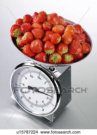 Picture - Kitchen Scales With Strawberries - Non Exclusive. Fotosearch