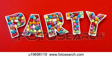 Stock Photo - Party chocolate candies on Red - Non Exclusive. Fotosearch