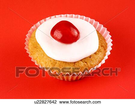 Stock Image - Single Cupcake on Red - Non Exclusive. Fotosearch
