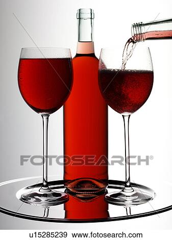 Stock Photo - Two Glasses of Rose Blush Wine With Bottle - Non Exclusive. Fotosearch