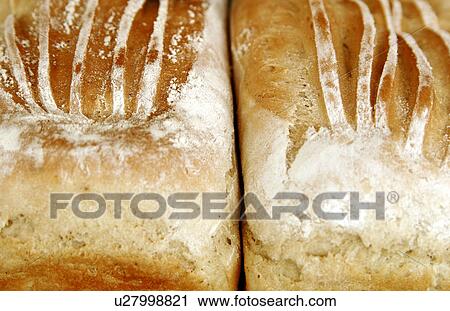Stock Image - Two handmade white tin loaves. Fotosearch
