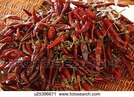 Stock Image - Bunch of dried red chilli peppers. Fotosearch