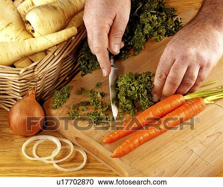 Stock Image - Chopping Parsley - Non Exclusive. Fotosearch