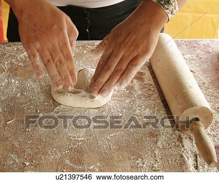 Stock Photograph - Kneading naan bread dough. Fotosearch