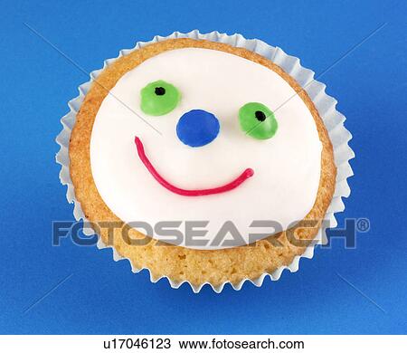 Single Face Cupcake on Blue- Non Exclusive View Large Photo Image Stock Image - Single Face Cupcake on Blue- Non Exclusive. Fotosearch
