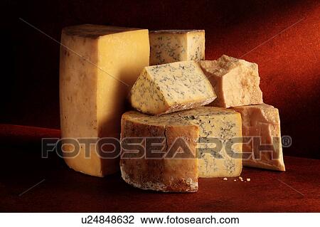 Stock Image - Stilton and Cheddar cheeses. Fotosearch