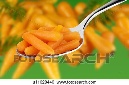 Stock Photograph - Baby Carrots On Spoon - Non Exclusive. Fotosearch