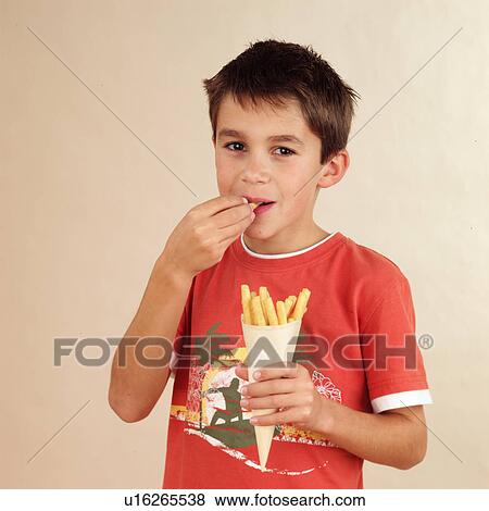 Stock Photo - Child eating pastry sticks. Fotosearch