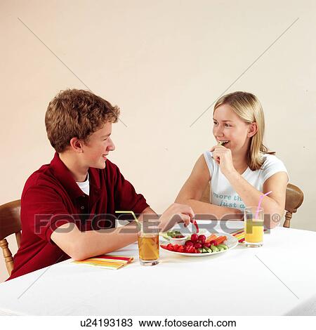 Stock Image - Children eating and drinking. Fotosearch