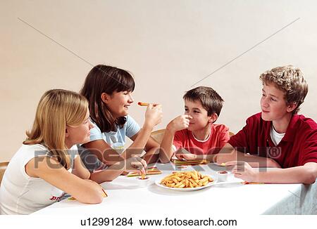 Picture - Children eating. Fotosearch
