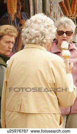 Stock Photo - Enjoying an ice cream. Fotosearch